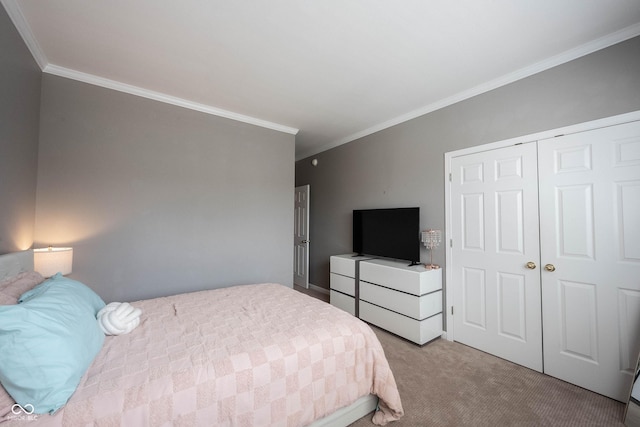 bedroom featuring crown molding, light colored carpet, and a closet