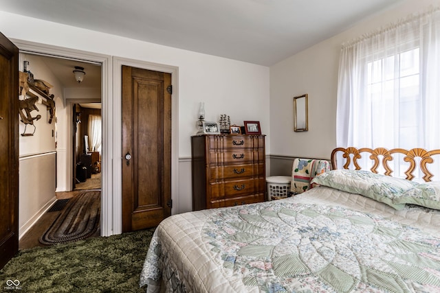 bedroom featuring dark colored carpet