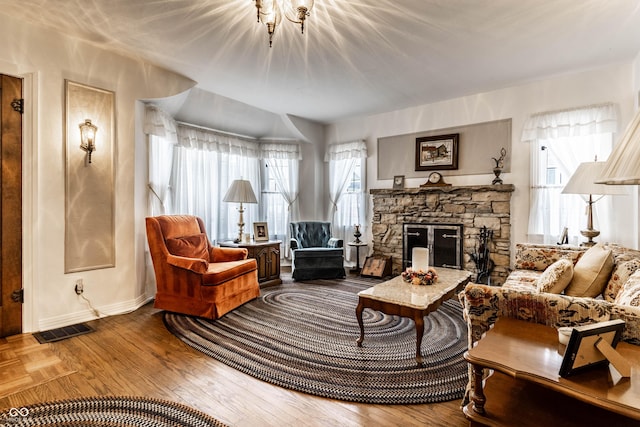 sitting room featuring wood-type flooring and a fireplace