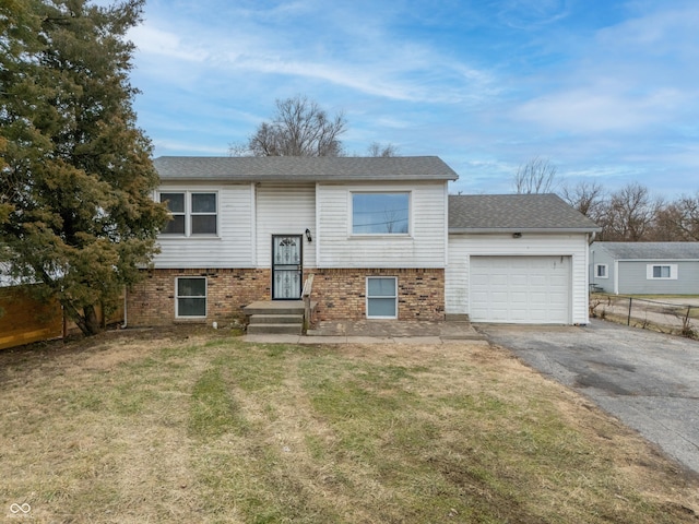 bi-level home featuring a garage and a front yard