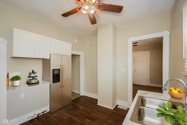 kitchen with sink, stainless steel fridge, ceiling fan, dark hardwood / wood-style floors, and white cabinets