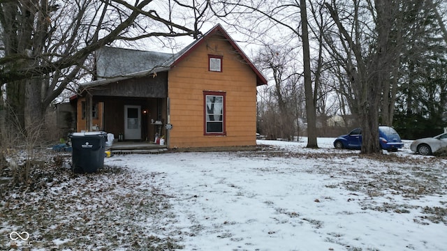 view of snow covered rear of property