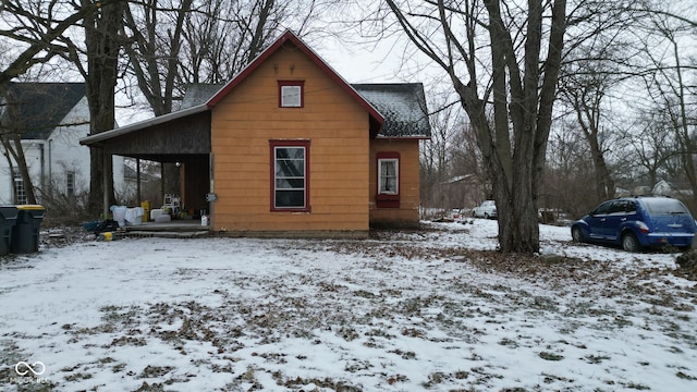 view of snow covered rear of property