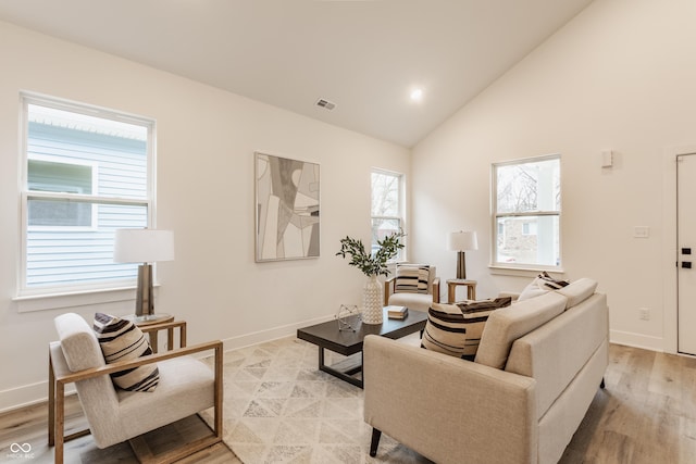 living room with light hardwood / wood-style flooring and vaulted ceiling