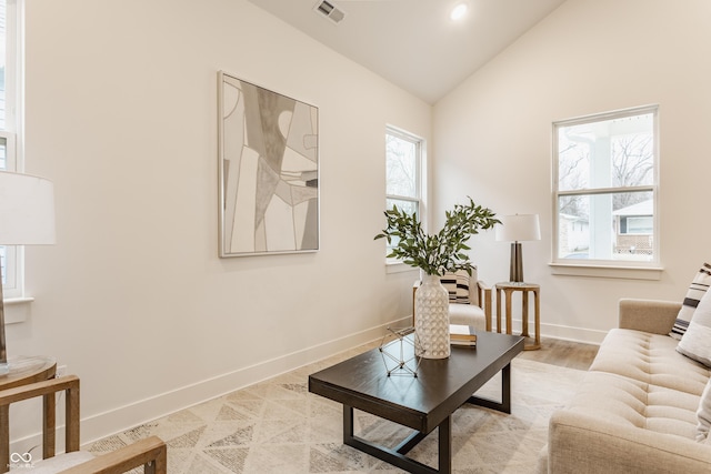 sitting room with lofted ceiling