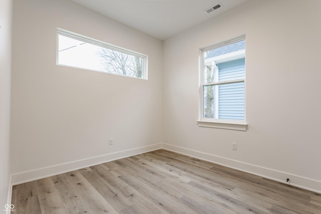 unfurnished room with light wood-type flooring