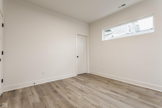 unfurnished room featuring light hardwood / wood-style floors