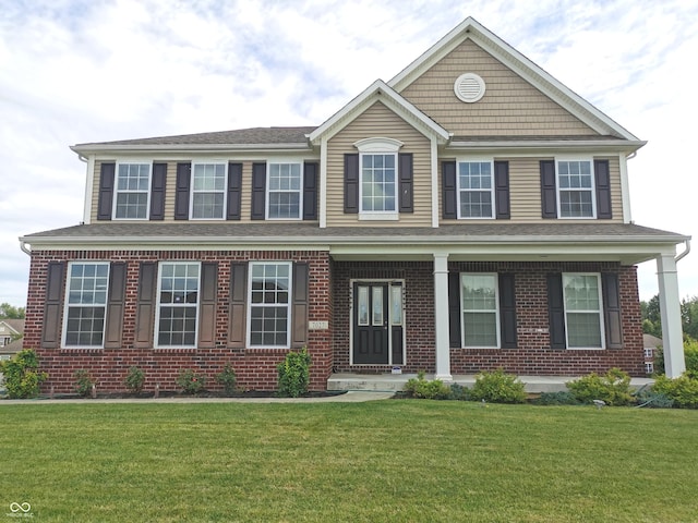 view of front of home featuring brick siding and a front yard