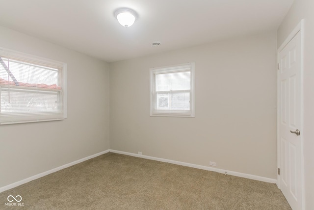 unfurnished room with light colored carpet