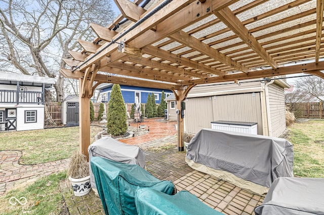 view of patio featuring a pergola and a shed