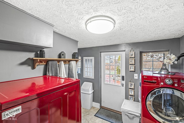 washroom with washer and dryer and a textured ceiling