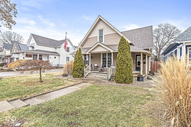 view of front of house featuring covered porch and a front lawn