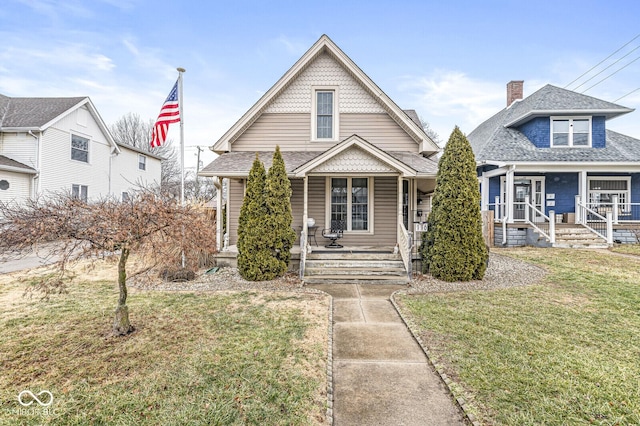 view of front facade with a front yard and a porch