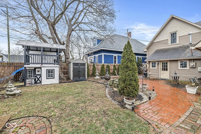 back of property featuring a shed and a lawn