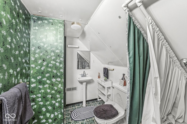 bathroom featuring lofted ceiling