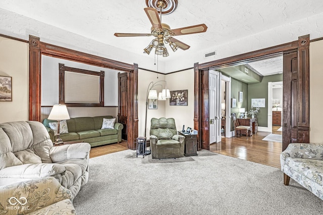 living room featuring hardwood / wood-style flooring and ceiling fan