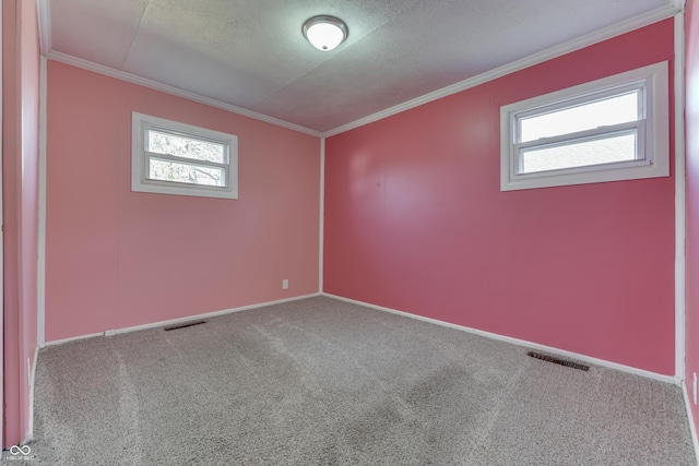 unfurnished room with ornamental molding, a healthy amount of sunlight, and carpet