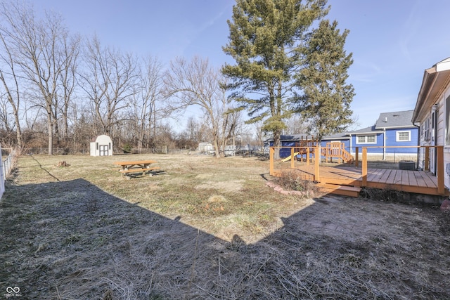 view of yard with a storage unit and a deck