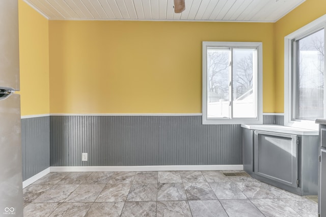 spare room featuring wood ceiling and wood walls