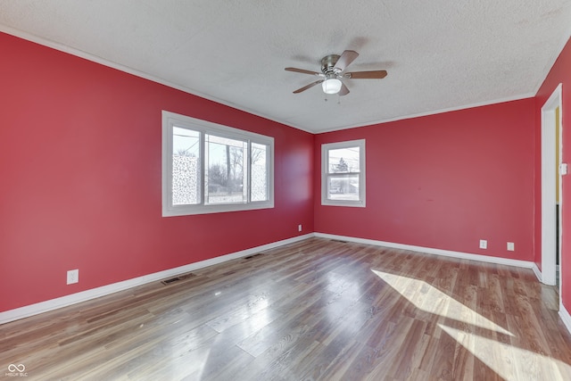 empty room with ceiling fan, a textured ceiling, and light wood-type flooring