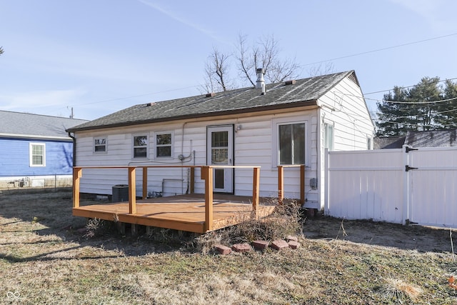 rear view of house featuring a wooden deck