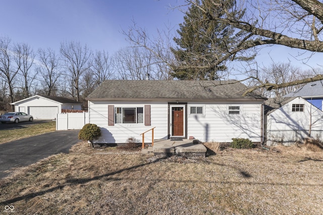 single story home featuring an outbuilding and a garage