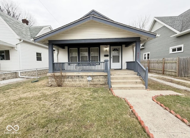 view of front facade featuring covered porch and a front yard