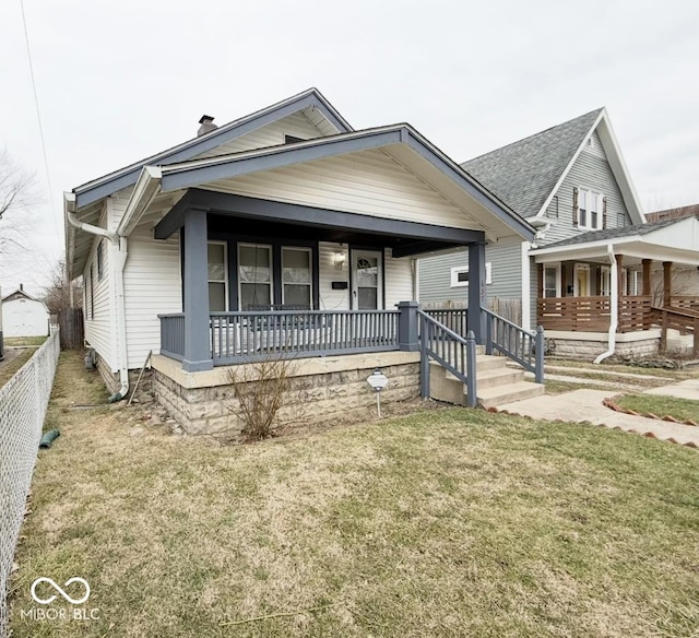 view of front of property with a porch and a front lawn