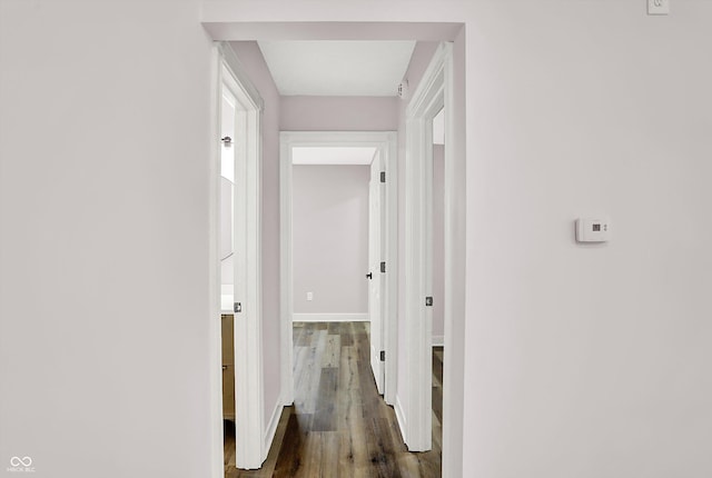 corridor with dark hardwood / wood-style floors