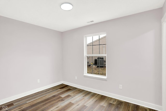 spare room featuring wood-type flooring