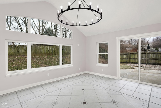 unfurnished dining area featuring a chandelier, high vaulted ceiling, and light tile patterned floors