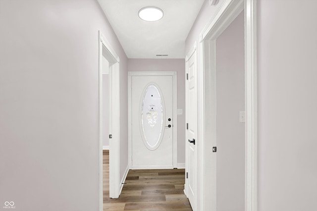 doorway with hardwood / wood-style floors