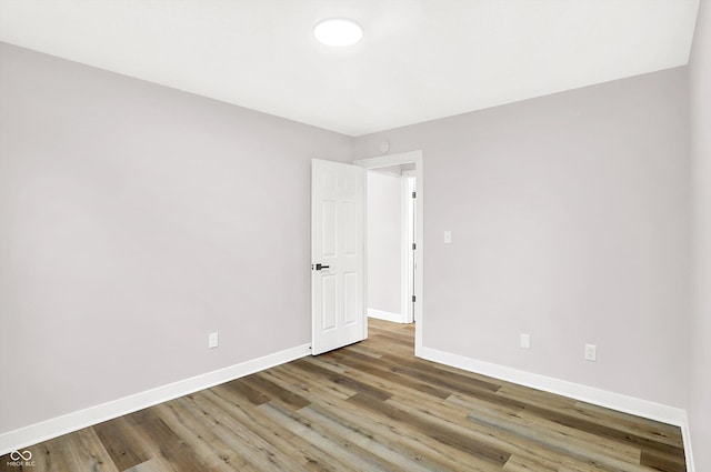 unfurnished room with hardwood / wood-style floors