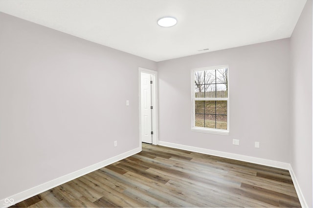 unfurnished room with wood-type flooring