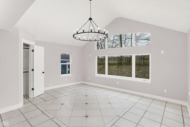 spare room with an inviting chandelier, high vaulted ceiling, and light tile patterned flooring