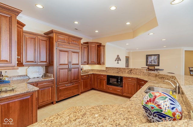 kitchen featuring light stone countertops, sink, black microwave, and light tile patterned floors