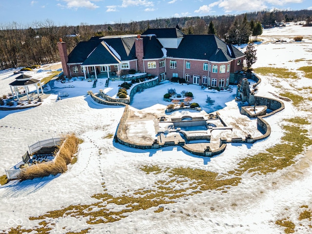 view of snow covered back of property