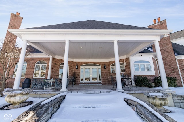 view of front of house featuring a porch and french doors