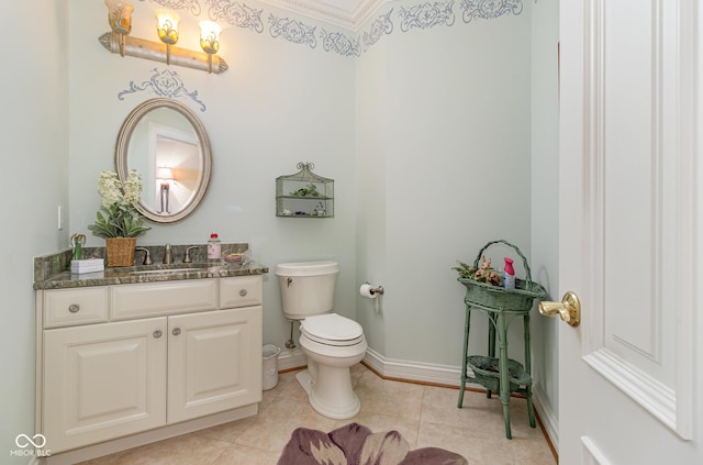 bathroom with vanity, toilet, and tile patterned flooring