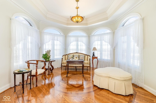 sitting room featuring a tray ceiling, ornamental molding, and hardwood / wood-style flooring