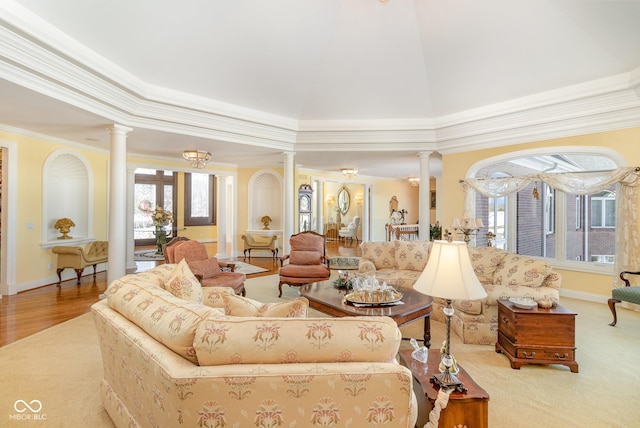 living room featuring crown molding and ornate columns