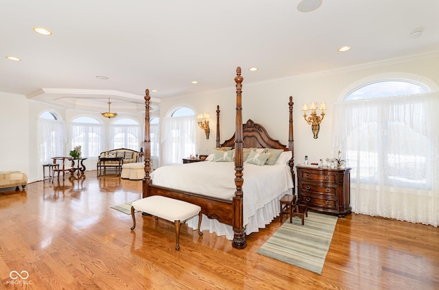 bedroom featuring ornamental molding and light wood-type flooring