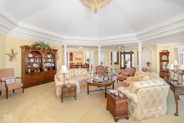 living room with lofted ceiling, ornamental molding, decorative columns, and light carpet