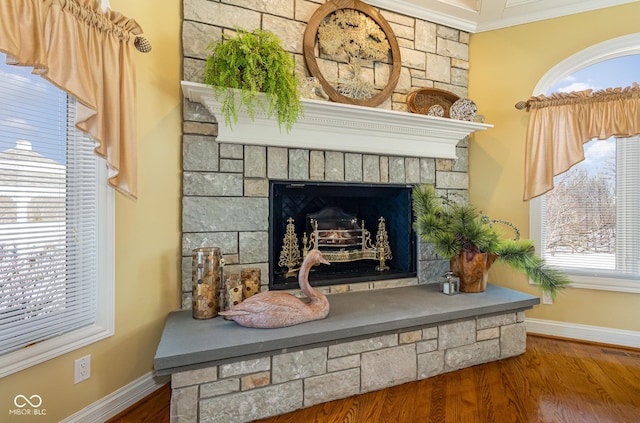 interior details with a stone fireplace and hardwood / wood-style floors