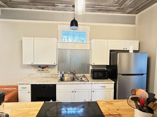 kitchen with hanging light fixtures, white cabinetry, sink, and black appliances