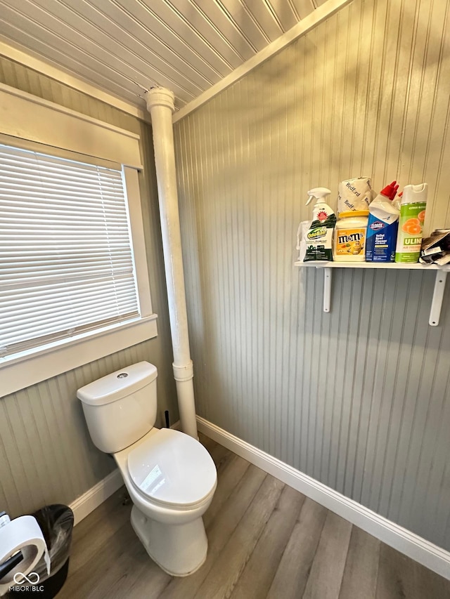 bathroom with wood-type flooring, toilet, and ornate columns