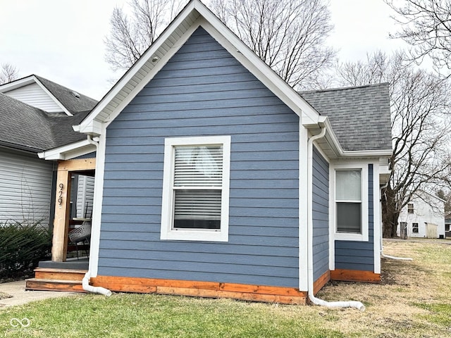 view of side of property with a lawn