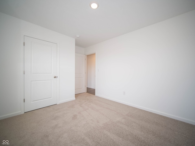 unfurnished bedroom with carpet, baseboards, and recessed lighting