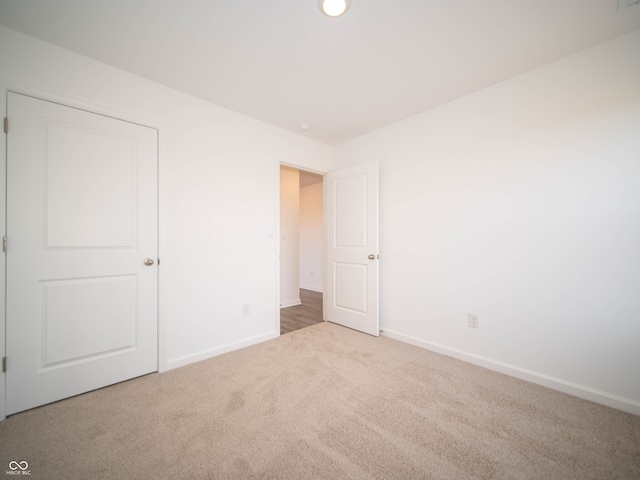 unfurnished bedroom with baseboards and carpet flooring