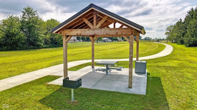 view of property's community with a patio area, a gazebo, and a yard